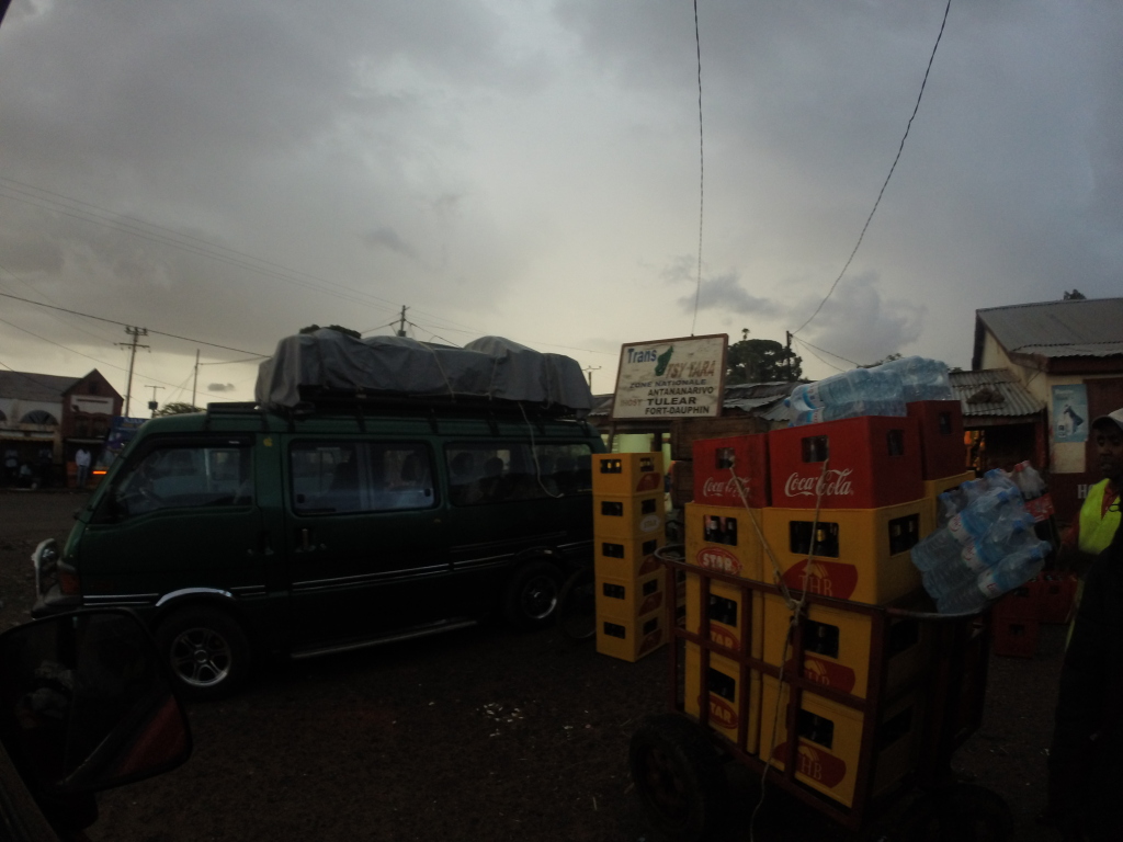 An image at the taxi-brousse station. There are usually dozens of these vehicles packed and loaded, just waiting to fill up before they head to their destination.