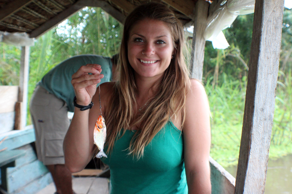 Holding up my very first piranha. How cute is it?!