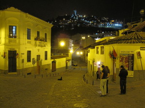A view of one of the streets close to La Ronda with a night view of the Madonna on El Panecillo.