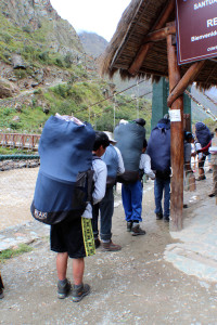The line-up of porters waiting to go through the control booth with their backpacks full of  25kg of gear.