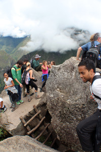 A view of the boulder atop Huayna Picchu. And in the right corner, the guy who almost fell of the rocks just to take a photo of me.